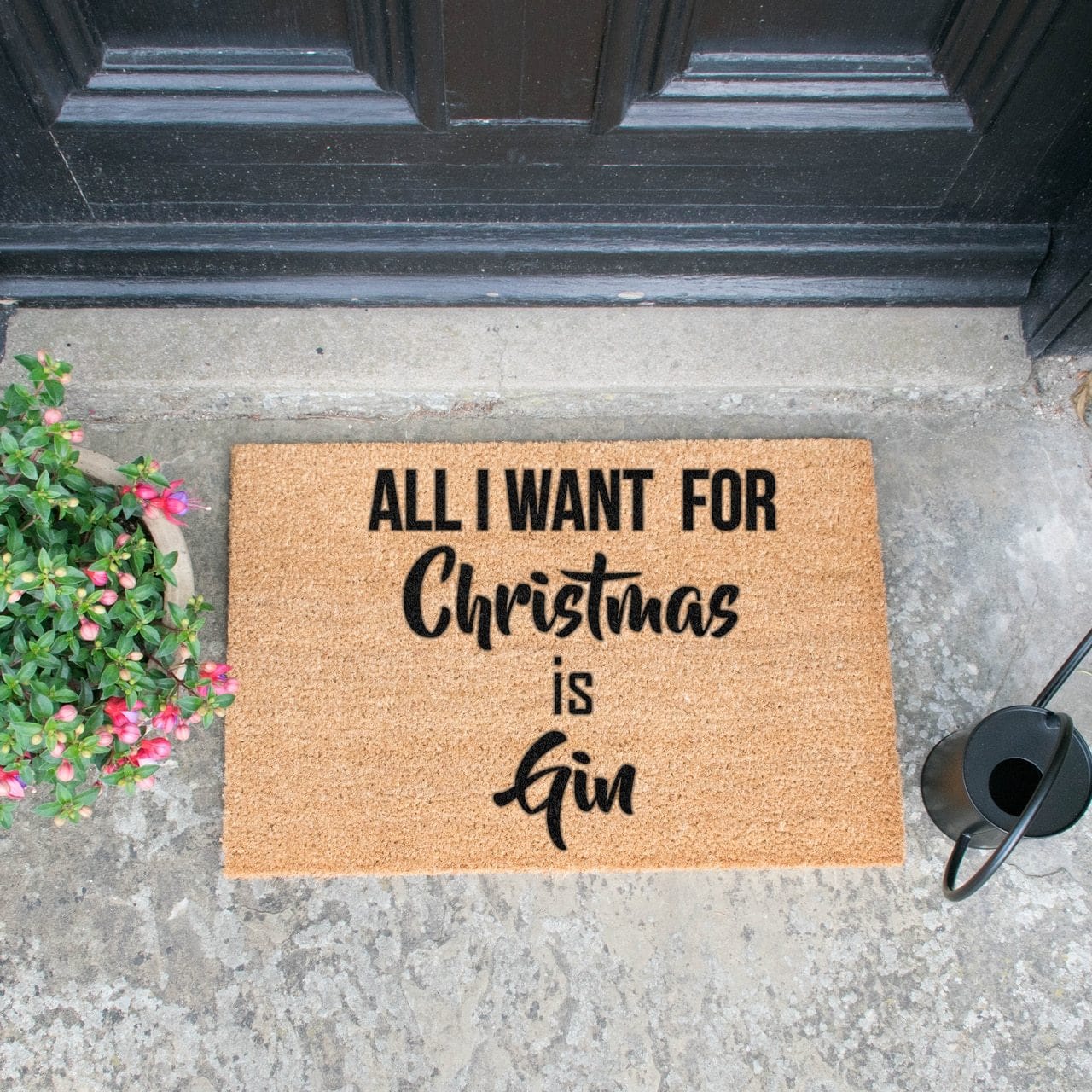 Welcome doormat in porch with 'All I Want For Christmas Is Gin' slogan  