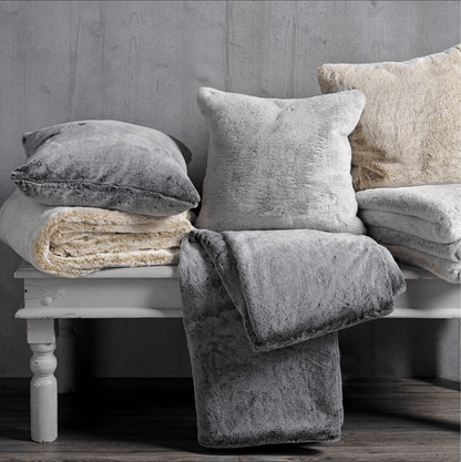 Tipped Faux Fur Throw in Charcoal by Walton & Co. lifestyle image with cushions.